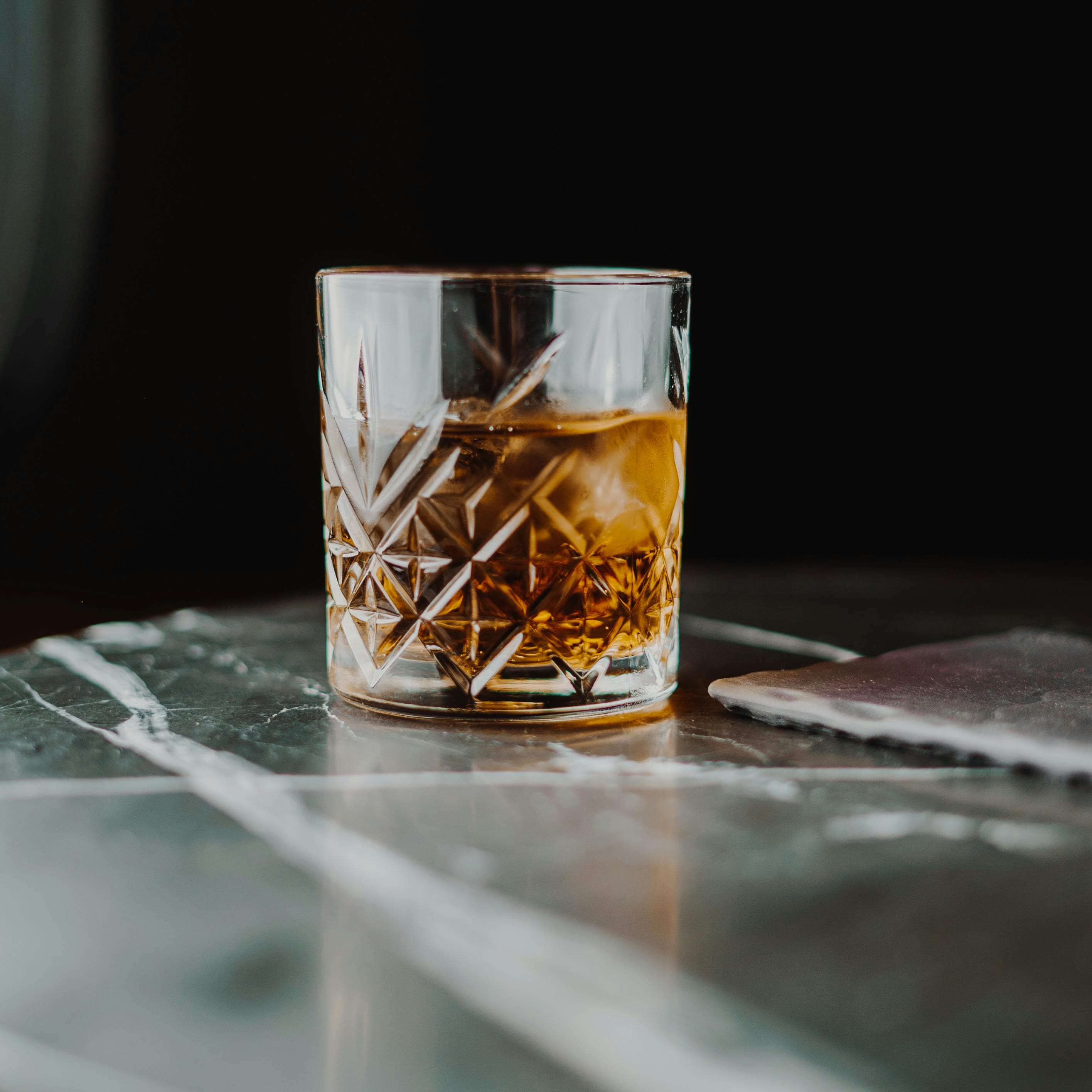 Bourbon in a crystal glass on marble